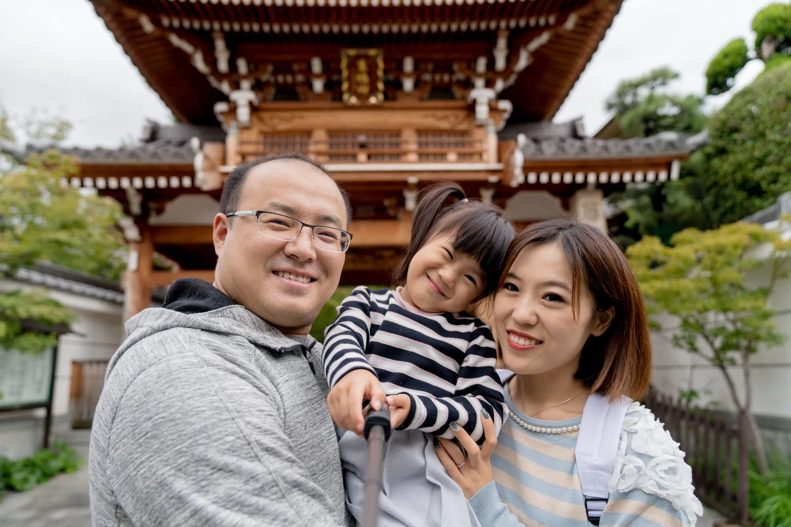 Group of travelers walking through a quiet Japanese neighborhood